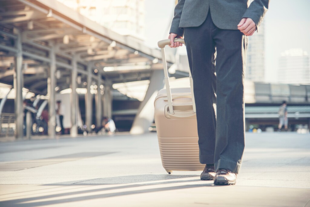 traveling employee walking with suitcase
