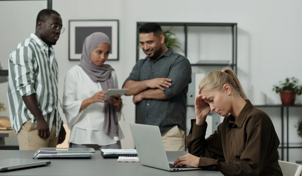 worried woman working with colleagues at desk